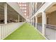 Dog park with artificial turf, alongside covered parking and residential buildings at 800 Peachtree Ne St # 2304, Atlanta, GA 30308