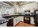 White cabinetry, granite countertops, and stainless steel appliances in a naturally lit kitchen at 800 Peachtree Ne St # 2304, Atlanta, GA 30308