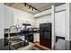 Modern kitchen with white cabinets, stainless steel appliances, and granite countertops at 800 Peachtree Ne St # 2304, Atlanta, GA 30308