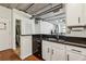 White cabinets and black granite countertops in this airy, naturally lit kitchen with open design at 800 Peachtree Ne St # 2304, Atlanta, GA 30308