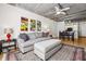 Comfortable living room, dining, and kitchen area with hardwood floors, modern lighting and open design at 800 Peachtree Ne St # 2304, Atlanta, GA 30308