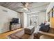 Cozy living room bathed in natural light with hardwood floors, comfy couch, and direct access to a balcony at 800 Peachtree Ne St # 2304, Atlanta, GA 30308