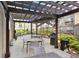 Outdoor dining area with a pergola covering tables, chairs, and a grill at 800 Peachtree Ne St # 2304, Atlanta, GA 30308