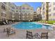 Resort-style pool with lounge chairs and well-manicured landscaping at a multi-story apartment complex at 800 Peachtree Ne St # 2304, Atlanta, GA 30308