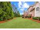 Expansive backyard features lush lawn, landscaping, and a wooden deck perfect for outdoor enjoyment at 1364 Gulfport Run, Grayson, GA 30017