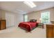 A basement bedroom featuring neutral walls, carpet, two windows, furniture, and a double door closet at 1364 Gulfport Run, Grayson, GA 30017
