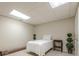 This basement bedroom features carpet, plants, minimal furniture, and flourescent lights at 1364 Gulfport Run, Grayson, GA 30017