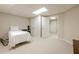 A basement bedroom with carpet, plants, minimal furniture, and doors to other parts of the house at 1364 Gulfport Run, Grayson, GA 30017