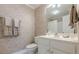This bathroom features neutral walls, a white vanity, a toilet, and a bathtub/shower combo at 1364 Gulfport Run, Grayson, GA 30017