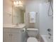 A white bathroom featuring a tub/shower combo, a white vanity, and a toilet at 1364 Gulfport Run, Grayson, GA 30017