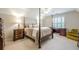 Bedroom featuring neutral carpet, natural light, and stylish wooden furniture at 1364 Gulfport Run, Grayson, GA 30017