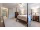 This bedroom features neutral carpet, natural light, stylish wooden furniture, and ceiling fan at 1364 Gulfport Run, Grayson, GA 30017