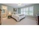 Charming bedroom featuring neutral walls, large windows, and an ensuite bathroom at 1364 Gulfport Run, Grayson, GA 30017