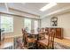 Traditional dining room featuring wood table, chairs, and sideboard with natural light from large windows at 1364 Gulfport Run, Grayson, GA 30017