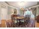 Formal dining room featuring a chandelier, large table with seating for eight, and elegant decor at 1364 Gulfport Run, Grayson, GA 30017