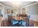 Formal dining area featuring a long table and seating, chandelier, and decorative wall mirror at 1364 Gulfport Run, Grayson, GA 30017