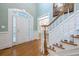 Inviting foyer featuring hardwood floors and a staircase with white railings and wooden handrail at 1364 Gulfport Run, Grayson, GA 30017