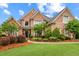 Charming front exterior with brick facade, manicured lawn, and beautiful landscaping, creating curb appeal at 1364 Gulfport Run, Grayson, GA 30017
