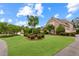 Beautiful brick home showcasing a well-manicured lawn, mature trees, and manicured shrubbery at 1364 Gulfport Run, Grayson, GA 30017