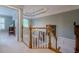 Bright hallway with chandelier, stairs, and doorway that leads into another room at 1364 Gulfport Run, Grayson, GA 30017