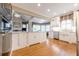 Spacious kitchen with hardwood floors, granite countertops, a farmhouse sink, and stainless steel appliances at 1364 Gulfport Run, Grayson, GA 30017