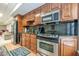 Updated kitchenette with stainless steel appliances, dark granite countertops, and wood cabinets at 1364 Gulfport Run, Grayson, GA 30017