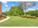 A well-maintained landscape features vibrant greenery, mature trees, and a winding walkway at 1364 Gulfport Run, Grayson, GA 30017