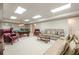 Spacious carpeted living area with a pool table, comfortable seating, and ample lighting at 1364 Gulfport Run, Grayson, GA 30017