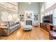 Bright and airy living room with a fireplace, built-in shelving, and large windows at 1364 Gulfport Run, Grayson, GA 30017