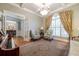 Sophisticated living room featuring coffered ceilings, plantation shutters, and elegant decor at 1364 Gulfport Run, Grayson, GA 30017