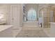 Main bathroom with soaking tub, separate shower, and tile flooring at 1364 Gulfport Run, Grayson, GA 30017