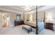 Main bedroom with a four-poster bed, tray ceiling, and neutral color scheme at 1364 Gulfport Run, Grayson, GA 30017
