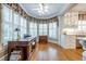 Bright office space with built-in shelving, hardwood floors, a large bay window, and a desk at 1364 Gulfport Run, Grayson, GA 30017