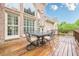 Outdoor patio features a dining table and chairs with a backdrop of a brick home facade at 1364 Gulfport Run, Grayson, GA 30017