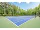 Well-maintained community tennis courts surrounded by lush trees and landscaping at 1364 Gulfport Run, Grayson, GA 30017