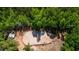Overhead shot featuring a sand arena, barns, and various sheds at 1369 N Highway 16, Whitesburg, GA 30185