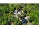 Aerial view of the property with multiple buildings, equipment and wooded acreage at 1369 N Highway 16, Whitesburg, GA 30185