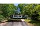 Exterior view of the home with a carport and green surroundings at 1369 N Highway 16, Whitesburg, GA 30185