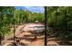Equestrian property featuring a horse arena surrounded by mature trees at 1369 N Highway 16, Whitesburg, GA 30185