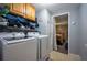 Laundry room with front-loading washer and dryer, plus upper cabinet storage at 1369 N Highway 16, Whitesburg, GA 30185