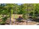 A rural property featuring mature trees, a trailer, and heavy equipment at 1369 N Highway 16, Whitesburg, GA 30185