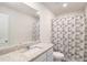 Bathroom features a granite countertop vanity, a large mirror, and a shower-tub combo with curtain at 231 Limestone Cir, Conyers, GA 30013
