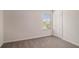 This is a spacious bedroom with neutral carpet, a window providing natural light, and a closet at 231 Limestone Cir, Conyers, GA 30013