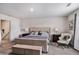 Comfortable bedroom with a well-made bed, side tables, lamps, and a sitting chair at 231 Limestone Cir, Conyers, GA 30013