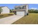 Attractive gray home with a well-maintained lawn and a convenient two-car garage at 231 Limestone Cir, Conyers, GA 30013