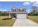 Charming two-story home featuring a manicured lawn, two-car garage, and inviting front porch at 231 Limestone Cir, Conyers, GA 30013