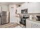Charming kitchen featuring stainless steel appliances, white cabinets and granite countertops at 231 Limestone Cir, Conyers, GA 30013