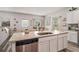 Spacious kitchen island with granite countertops, a stainless steel dishwasher, and a sink at 231 Limestone Cir, Conyers, GA 30013