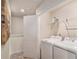 Functional laundry room with washer, dryer, overhead shelving, and plenty of space for sorting and folding at 231 Limestone Cir, Conyers, GA 30013