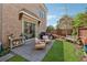 Charming backyard features a stone patio, grill, and lush greenery, creating a serene outdoor living space at 260 Jasmine Garden Way, Alpharetta, GA 30009